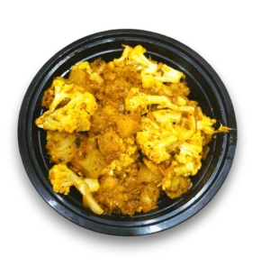 A flavorful serving of aloo gobhi from The Mum's Kitchen Tiffin and Catering Service, featuring tender potatoes and cauliflower cooked with aromatic spices and herbs. The dish is presented in a vibrant bowl, showcasing its inviting golden hue, perfect for a comforting meal.